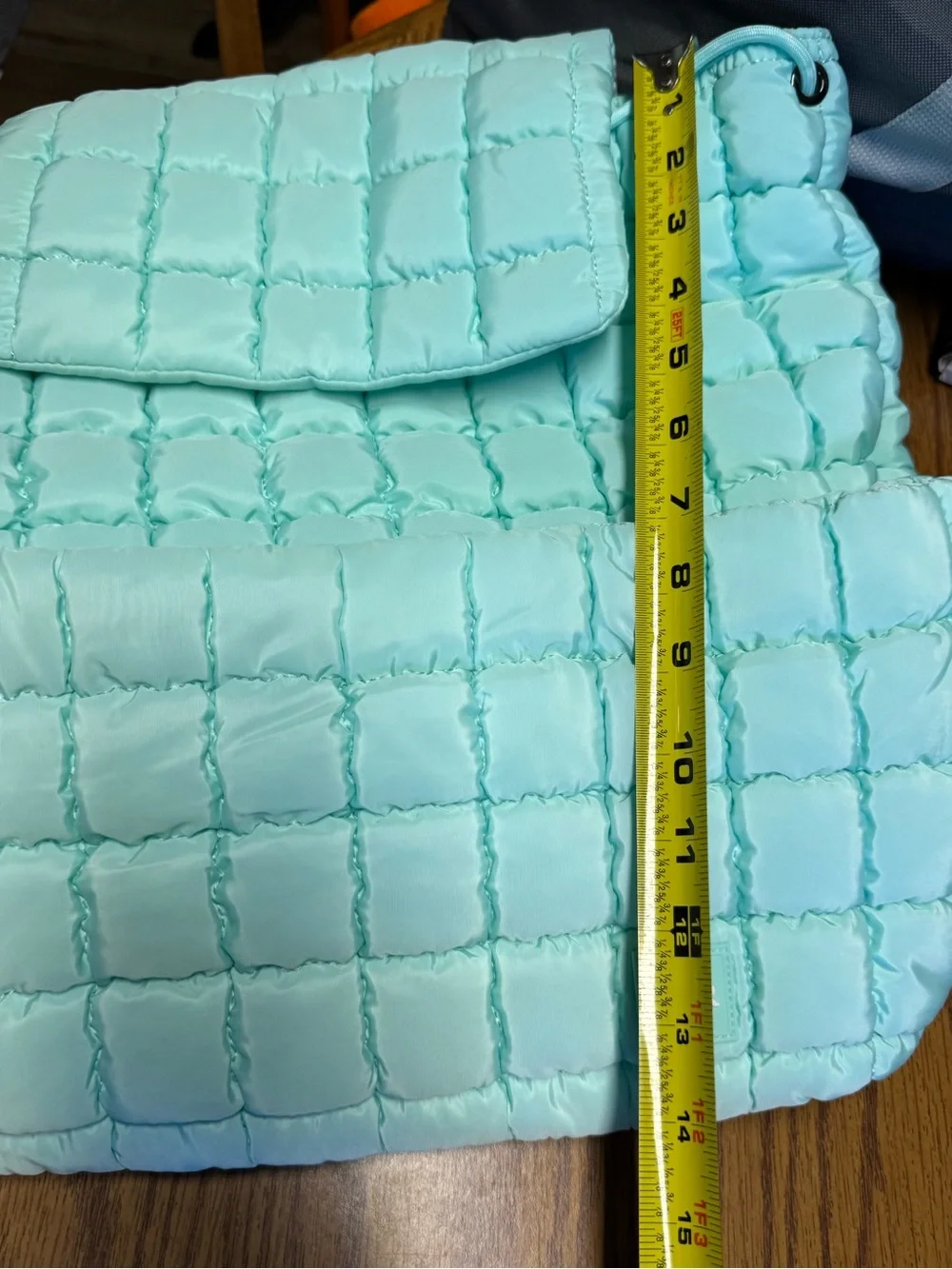 Iris Puff Backpack by Iris & Rainbow features a mint green quilted puffer design